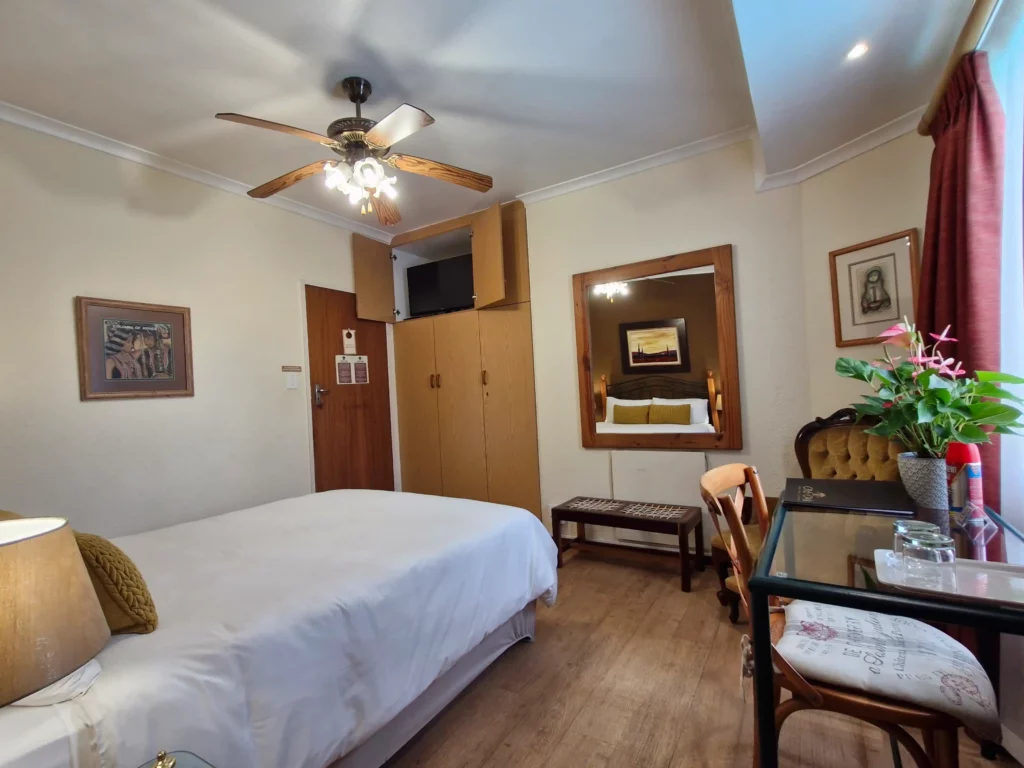 Guest room with bed and desk