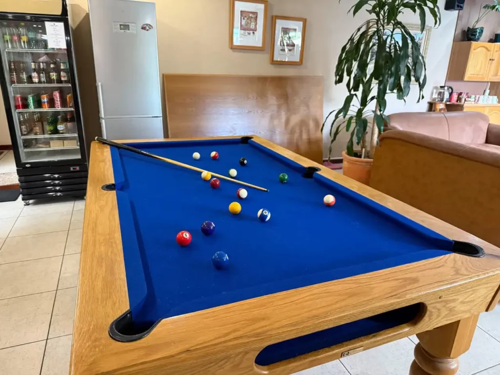 Blue felt pool table with balls